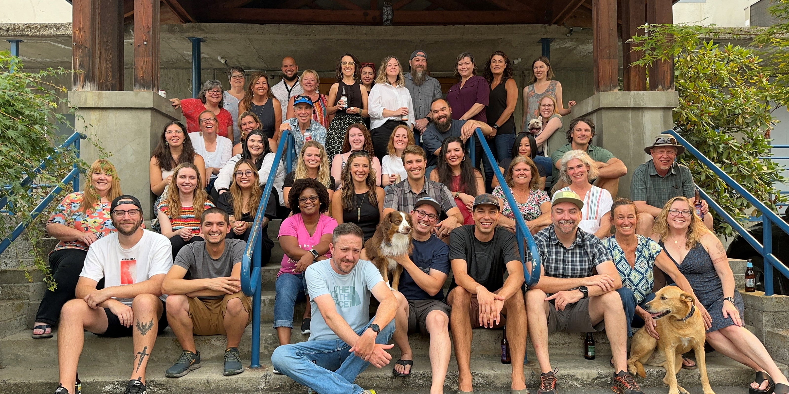 A photo of Sunday Afternoons employees sitting on the steps of the headquarters building.