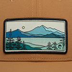Patch with mountain and landscape design on a brown surface