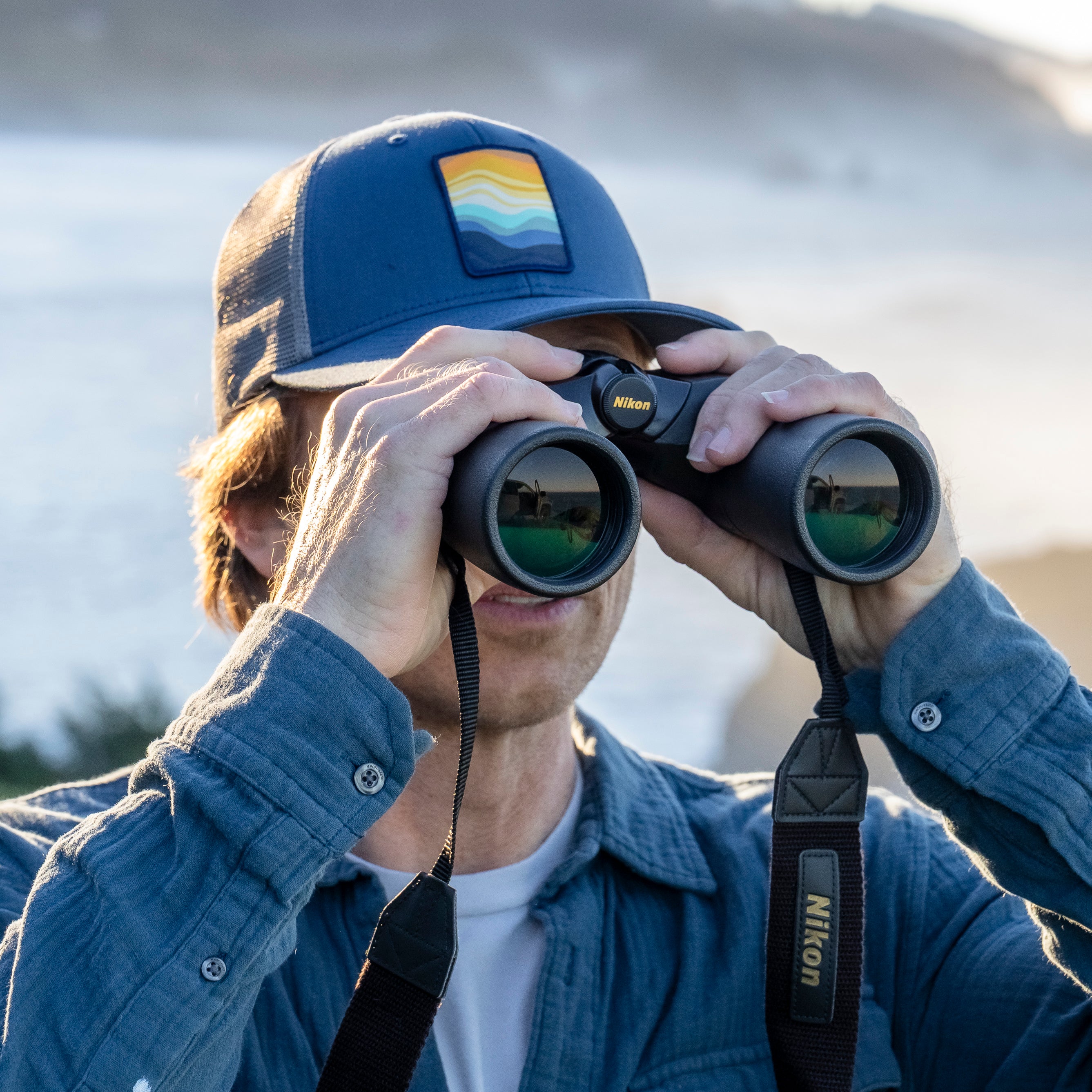 A man wearing a Sunday Afternoons Sunday Trucker in the Gradient Skies color. 